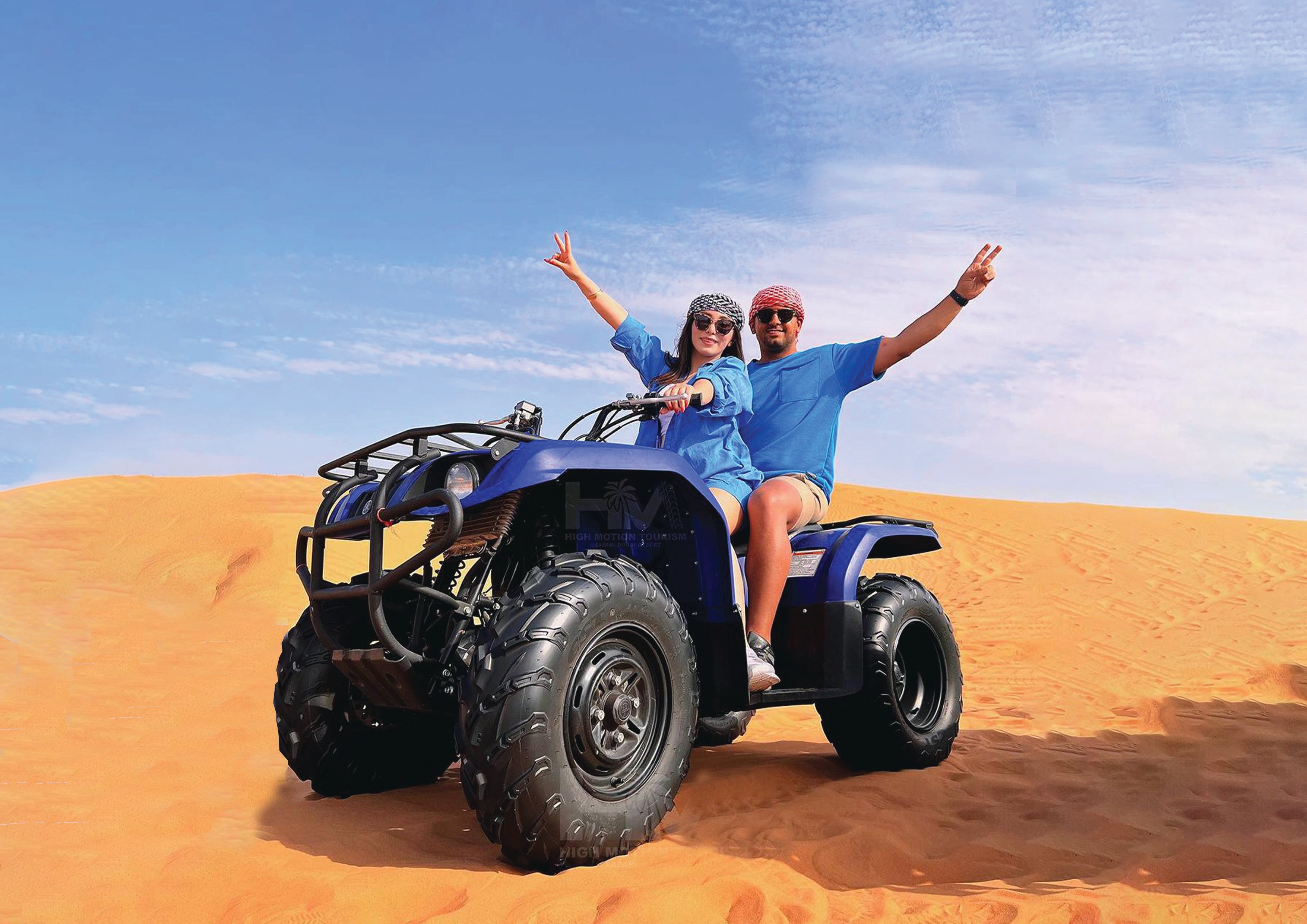 Couple riding a quad bike in the desert